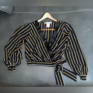 A.Calín by Flying Tomato Wrap Blouse
Size Medium
Black + Gold Stripe